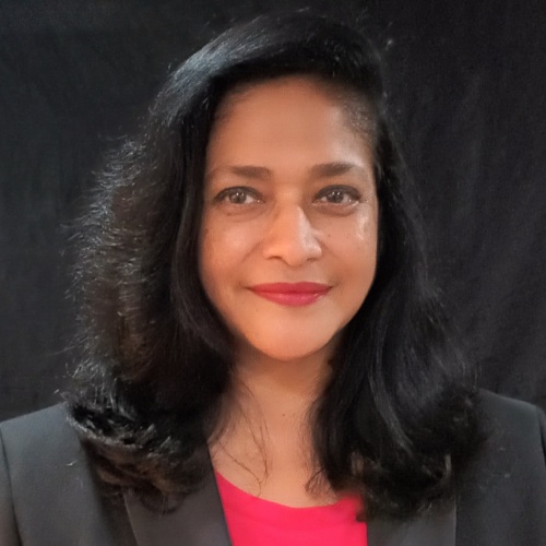 Woman with long black hair, wearing a black jacket.