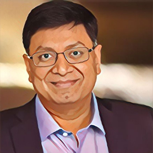 Man wearing glasses and a suit smiling.