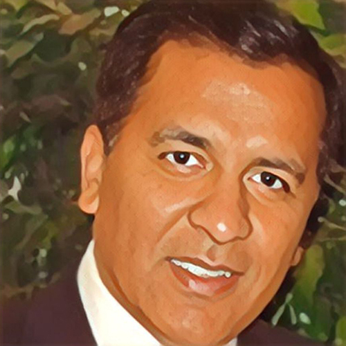 Portrait of a smiling man with dark hair.