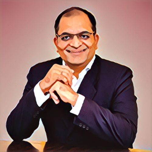Man in suit with hands clasped.